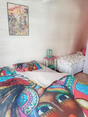 a room with two beds and a painting on the wall at RAINBOW HOME in Gornji Štoj