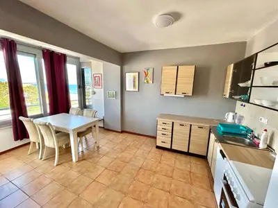 a kitchen with a table and chairs in a room at Romantica Apartments in Ulcinj