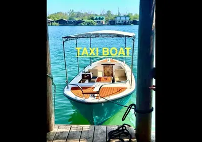 a small boat tied to a dock on the water at Romantica Apartments in Ulcinj