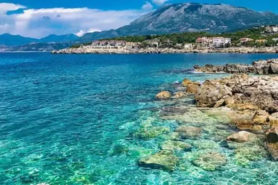 a body of water with rocks and a mountain at Guest House in Utjeha in Utjeha