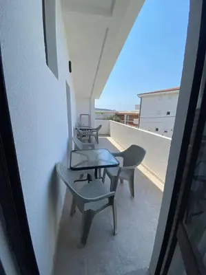 two chairs and a table on a balcony at Guest House in Utjeha in Utjeha