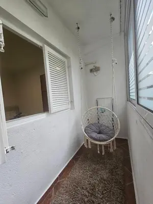 a swinging chair in a room with a window at Perovic 23 in Rafailovici