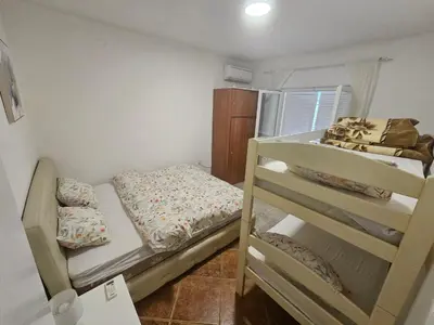 a small room with two bunk beds in it at Perovic 23 in Rafailovici