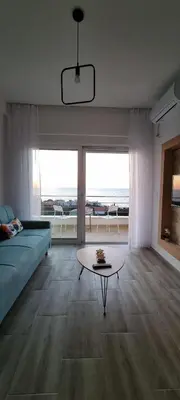 a living room with a couch and a table at Cold Bay Mansion Luxury Sea View Suites in Bar