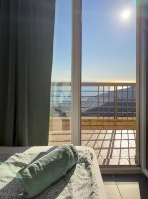 a bedroom with a window with a view of the ocean at Golden Horizon Villas in Budva