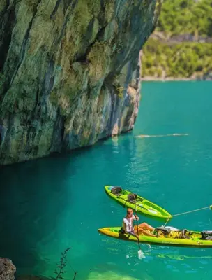 a man in a kayak in a body of water at Golden Horizon Villas in Budva