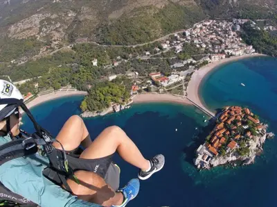 a person riding a zipline over the ocean at Golden Horizon Villas in Budva