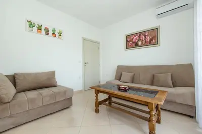 a living room with two couches and a coffee table at DITJONI in Ulcinj