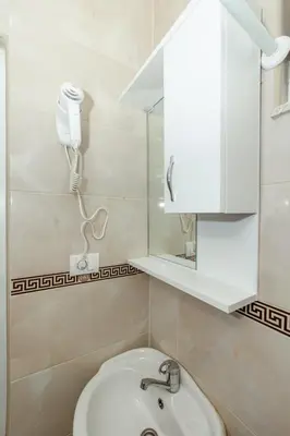 a bathroom with a sink and a phone on the wall at DITJONI in Ulcinj