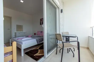 a bedroom with a bed and a table and a chair at DITJONI in Ulcinj
