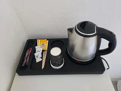 a tray with a tea kettle and a remote control at BOGUMILA in Bar