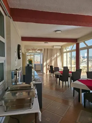 a dining room with tables and chairs and windows at BOGUMILA in Bar