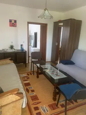 a living room with a bed and a coffee table at NIKOLA studio in Podgorica