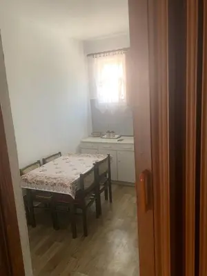 a dining room with a table and chairs and a window at NIKOLA studio in Podgorica