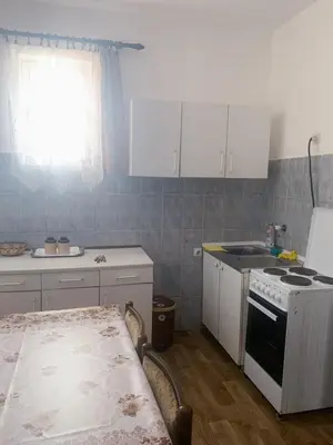 a kitchen with white cabinets and a stove top oven at NIKOLA studio in Podgorica