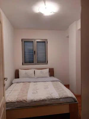 a bedroom with a bed with a light on the ceiling at Apartment Rozino in Budva