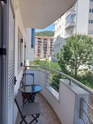 a balcony with a table and chairs on a balcony at Apartment Rozino in Budva