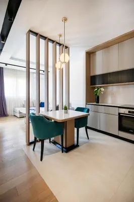a kitchen with a dining room table and chairs at Adriatic Dream Apartment Becici in Budva