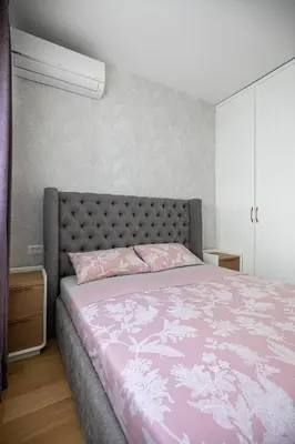 a bedroom with a bed with a pink comforter at Adriatic Dream Apartment Becici in Budva