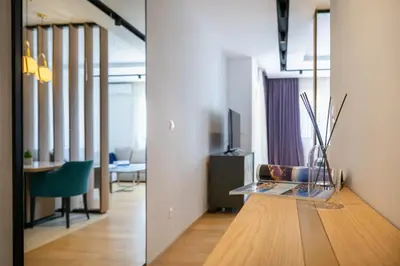 a living room with a glass table and a dining room at Adriatic Dream Apartment Becici in Budva