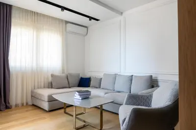 a living room with a couch and a table at Adriatic Dream Apartment Becici in Budva