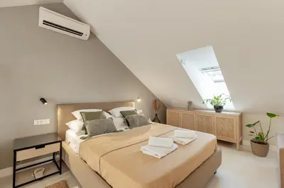 a bedroom with a large bed in a attic at Kotor Central Point in Kotor