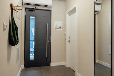 a black door in a room with a hallway at Kotor Central Point in Kotor