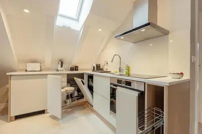 a kitchen with white cabinets and a sink at Kotor Central Point in Kotor
