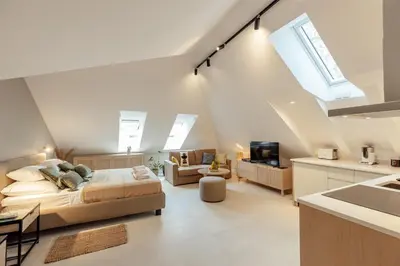 a bedroom with a bed and a kitchen with skylights at Kotor Central Point in Kotor