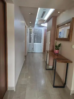 a hallway with a table and a hallway with a hallway at Studio K in Podgorica