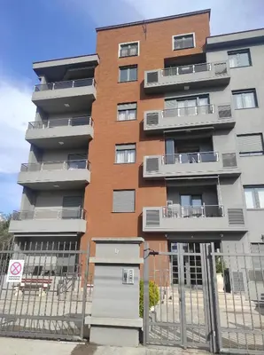 a tall building with a fence in front of it at Studio K in Podgorica