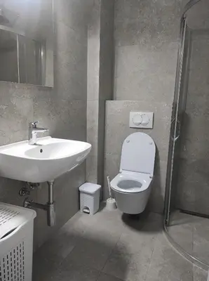 a bathroom with a sink and a toilet and a shower at Studio K in Podgorica