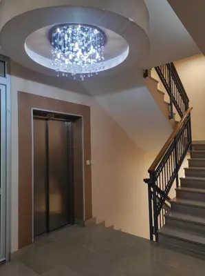 a ceiling with a chandelier in a hallway at Studio K in Podgorica