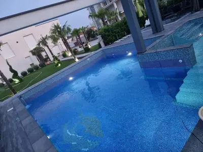 an overhead view of a large blue swimming pool at Villa „Taki“ Podgorica in Podgorica