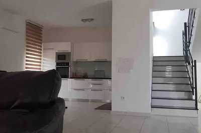a living room with a couch and a kitchen at Villa „Taki“ Podgorica in Podgorica