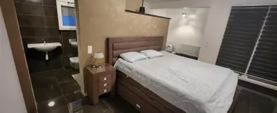 a bedroom with a bed and a sink and a bathroom at Villa „Taki“ Podgorica in Podgorica