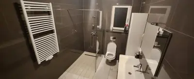a bathroom with a toilet and a shower and a sink at Villa „Taki“ Podgorica in Podgorica