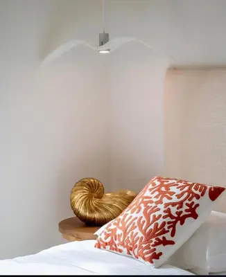 a bed with a wooden nightstand with a goldigunigun at The Rooftop of Apartments Lungo Mare in Ulcinj