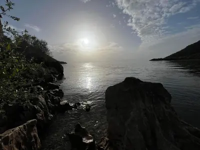 a view of a body of water with the sun at Lakeview Apartments Jolicic in Virpazar