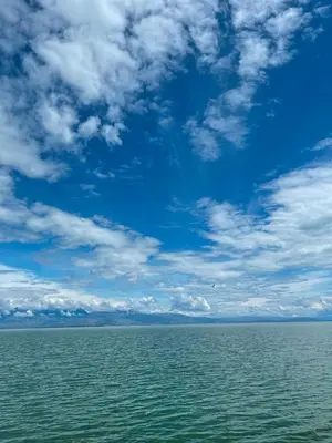 a large body of water with a blue sky and clouds at Lakeview Apartments Jolicic in Virpazar