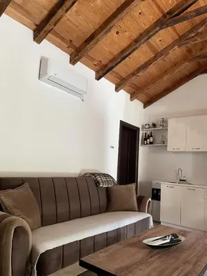 a living room with a couch and a table at Lakeview Apartments Jolicic in Virpazar