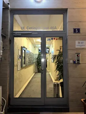 a door to a building with a sign on it at Thousand Roses in Podgorica