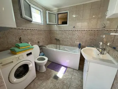 a bathroom with a washing machine and a sink at гостевой дом Polina2 in Gornji Sušanj