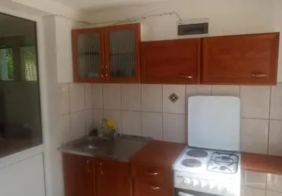 a kitchen with a white stove and a sink at гостевой дом Polina2 in Gornji Sušanj