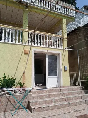 a house with stairs and a white door at гостевой дом Polina2 in Gornji Sušanj