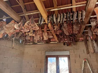 a bunch of meat hanging from the ceiling of a room at Vinogradina Eco Vukčević in Virpazar