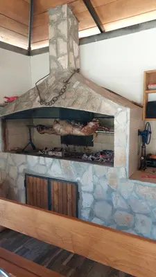 a large stone fireplace in a living room with at Vinogradina Eco Vukčević in Virpazar