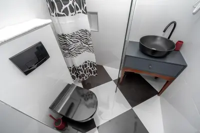 a small bathroom with a sink and a mirror at Baba's Hotel & Spa in Dobra Voda