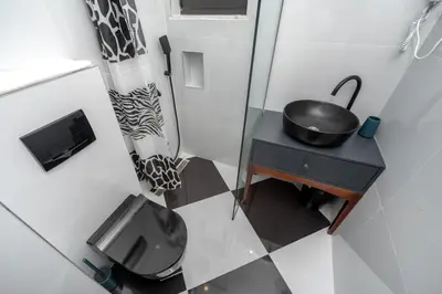a small bathroom with a toilet and a sink at Baba's Hotel & Spa in Dobra Voda