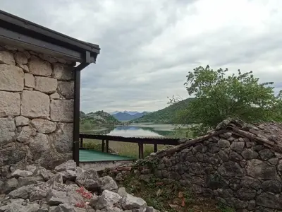 a view of a lake from a stone building at Feel the Karuch in Cetinje